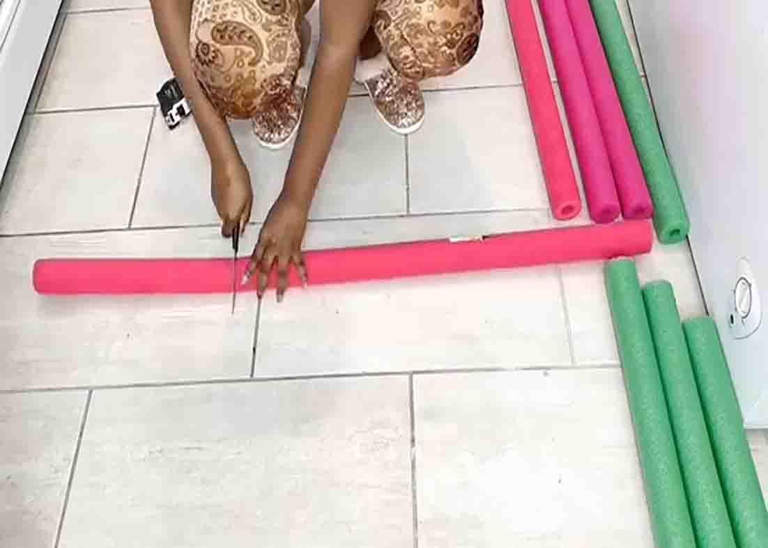 Cutting the pool noodles to make the the floor vase