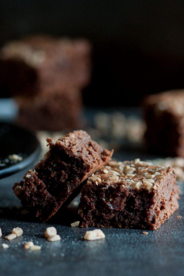 Toffee espresso brownies cut into squares with toffee bits on the crackled tops, on a dark slate surface