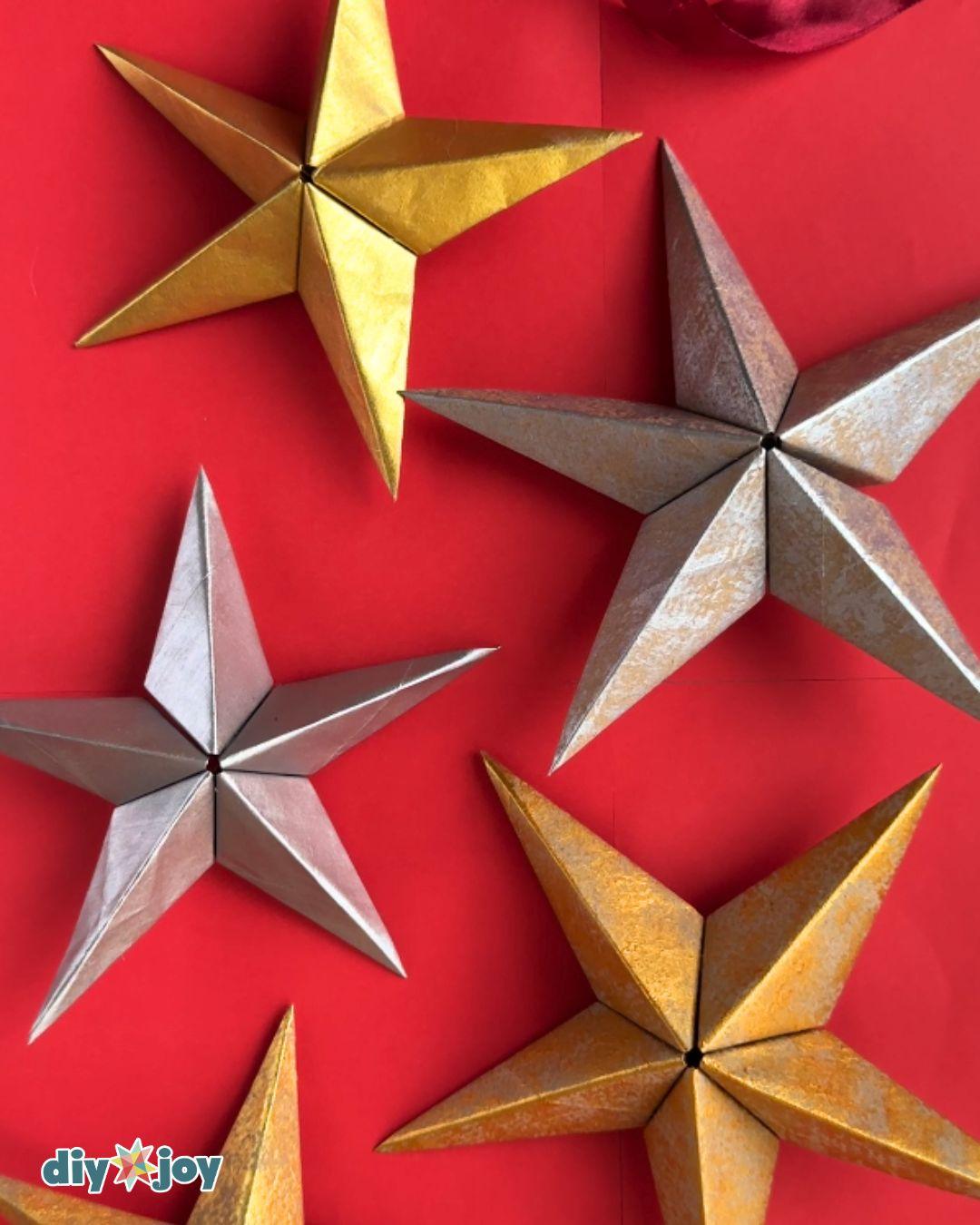 Paper bag star ornament collection - gold and silver 3D paper stars clustered together as holiday decor