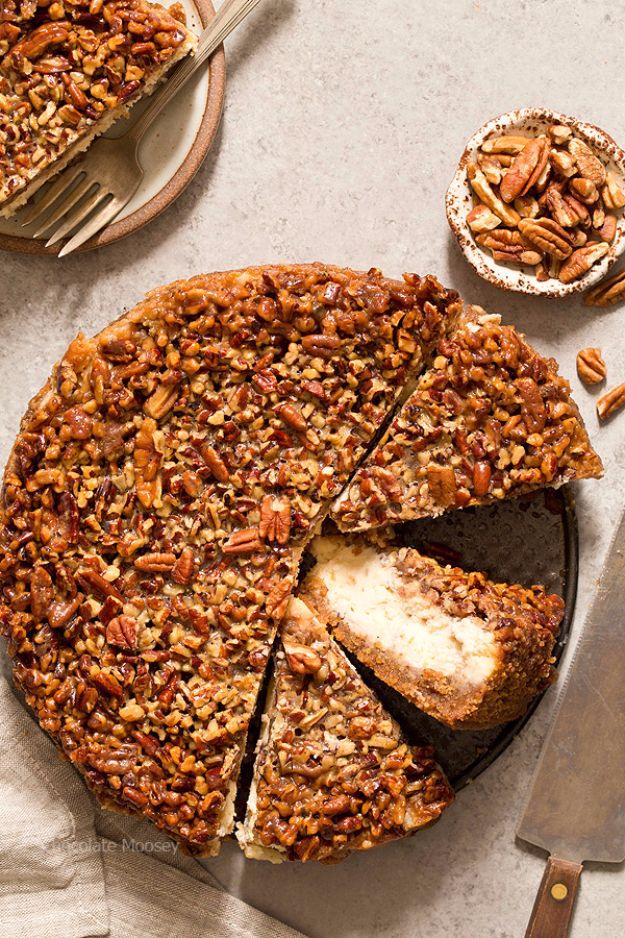 Pecan pie cheesecake with a thick caramel pecan topping, one slice pulled out to show the graham pecan crust
