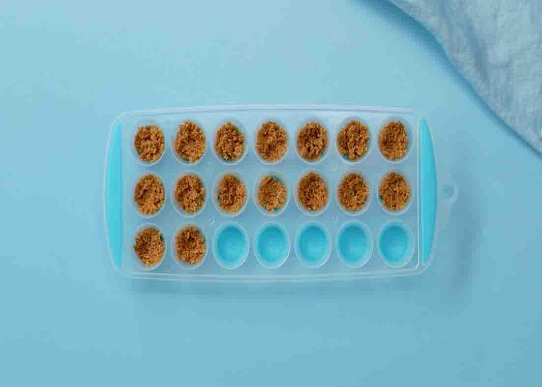 Placing the graham crackers to the ice tray for the bite-size smores