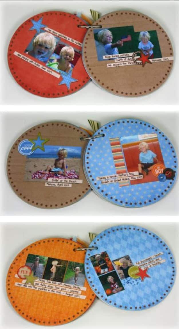 Three pairs of round scrapbook album pages made from CDs, papered in orange, blue and kraft and bound on rings