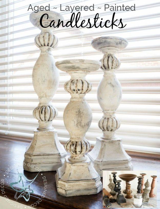 DIY aged layered painted candlesticks, three chunky cream distressed candlesticks standing on a wooden table