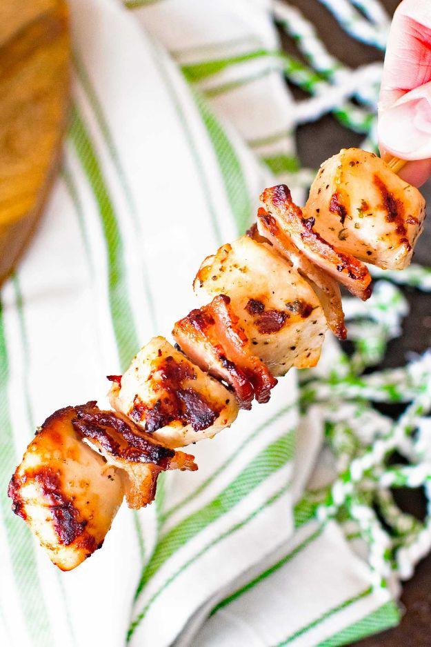 Bacon ranch chicken kabobs, a skewer of bacon wrapped grilled chicken pieces on a striped cloth napkin