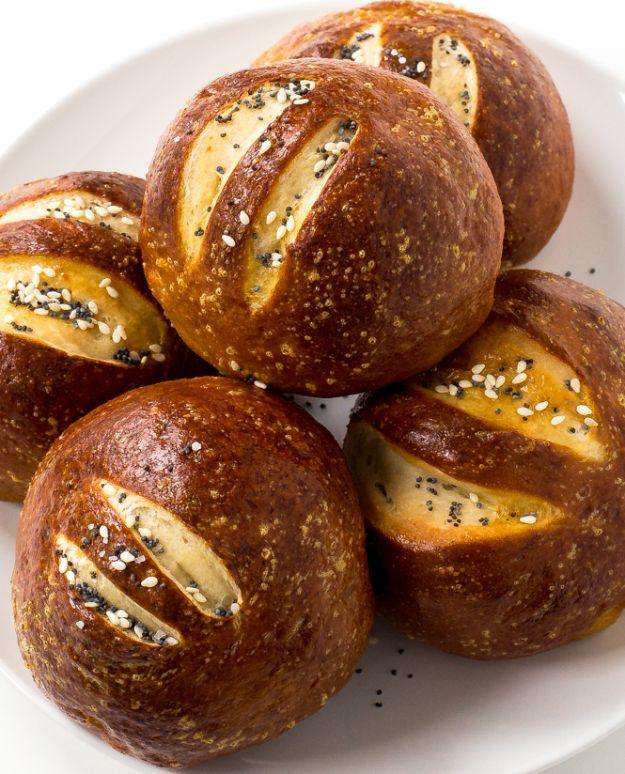 Homemade pretzel rolls with dark mahogany crusts topped with coarse salt, sesame seeds and poppy seeds