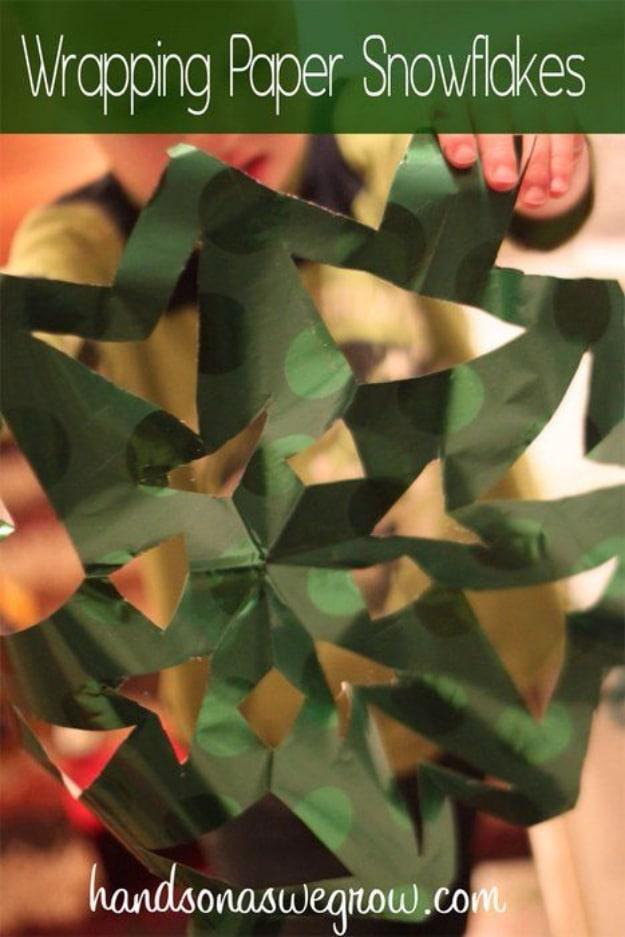 Wrapping paper snowflakes graphic showing a shiny green and gold cut paper snowflake held up by a child