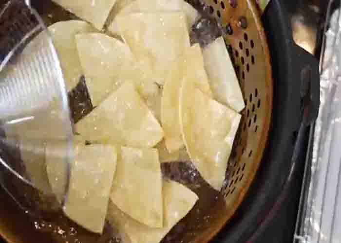 Frying the tortillas for the crab and meat nachos
