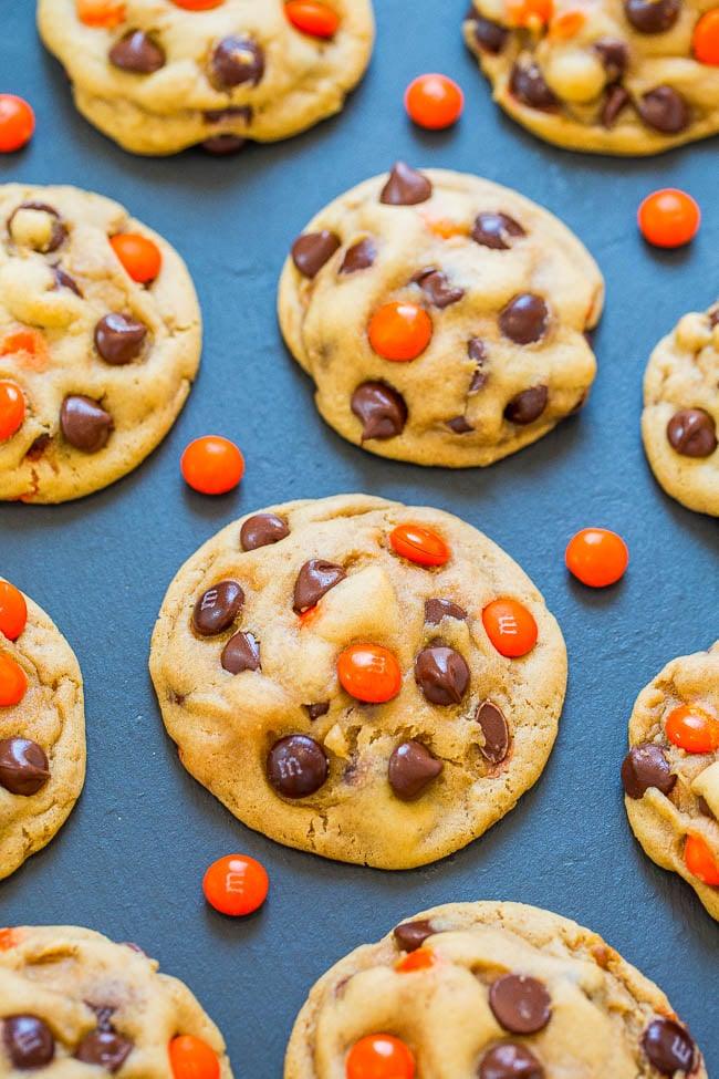 Soft chocolate chip cookies filled with orange and black Halloween candy pieces and extra chips on top