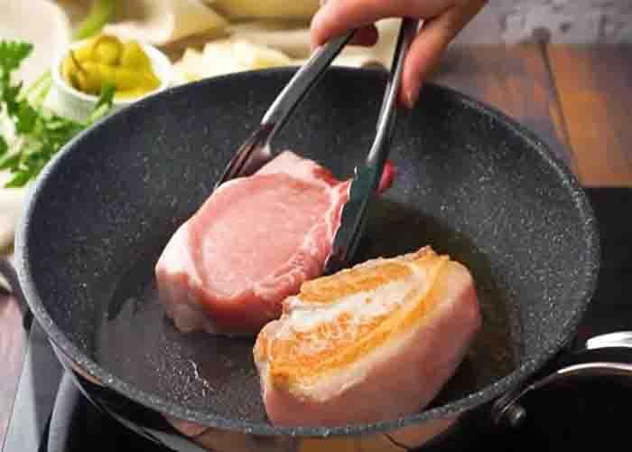Searing the pork chops before slow cooking them
