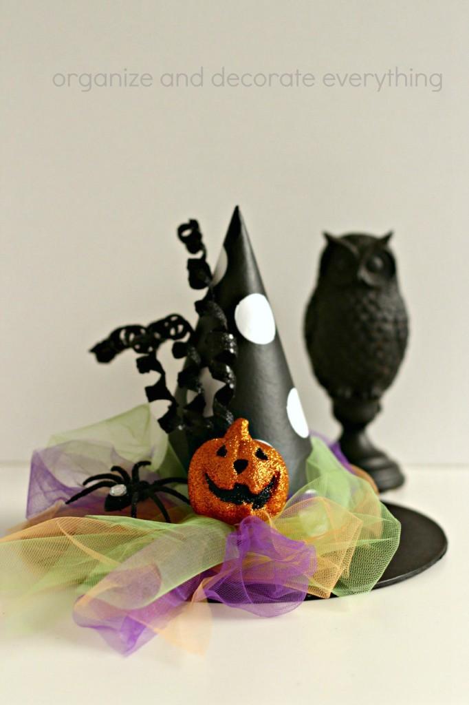 Black paper-mache witch hat with white dots, colorful tulle, glitter pumpkin and Organize and Decorate Everything watermark