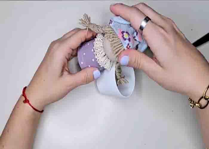 Attaching the head of the rag doll