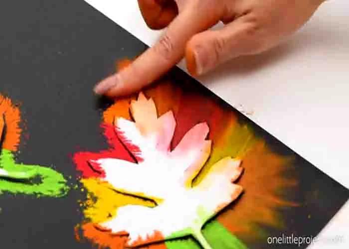 Smudging the chalk pastel on the black paper