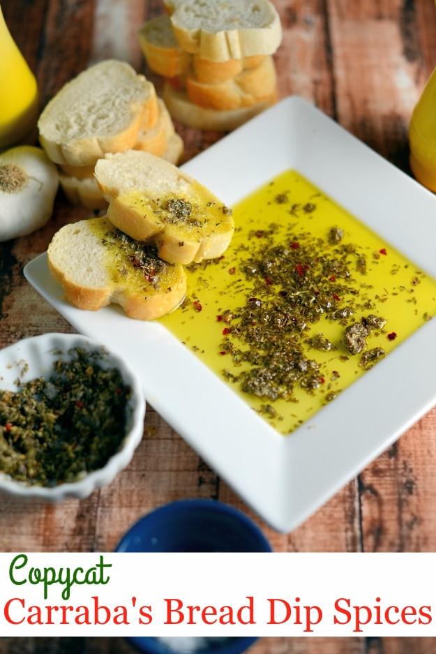 Copycat Carrabba's bread dip with herbs and crushed red pepper in olive oil beside torn crusty bread