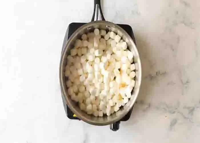 Melting the marshmallows for the popcorn balls recipe