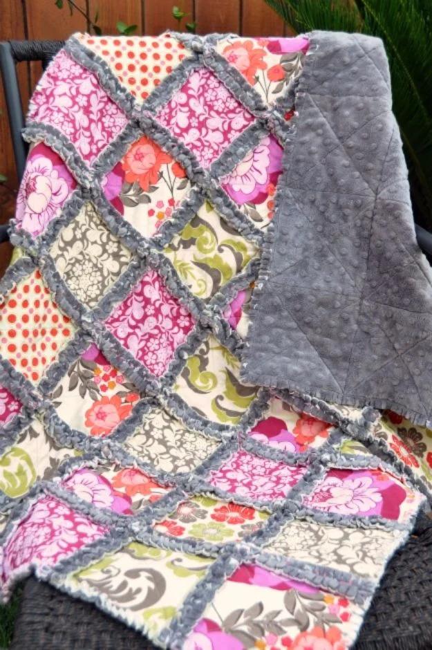 Minky rag quilt with hot pink and gray squares set on point, frayed seams and a gray minky back on a chair