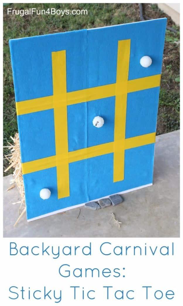 Sticky tic tac toe carnival game with a felt covered board taped into a grid and white ping pong balls stuck on