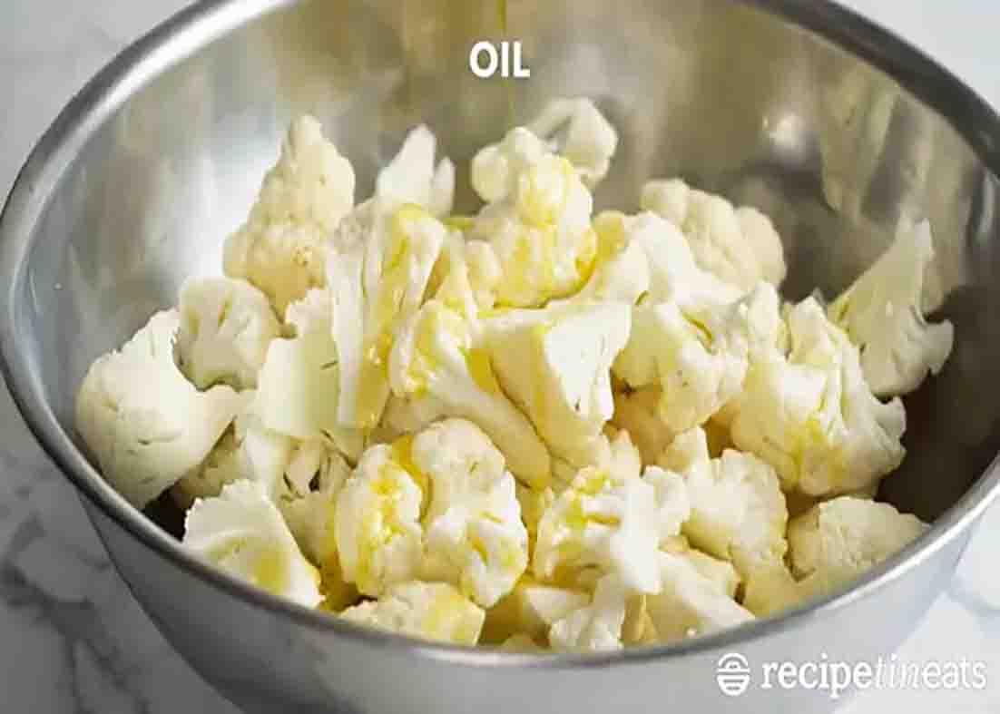 Seasoning the cauliflower before roasting