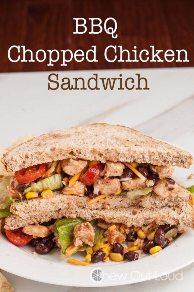 BBQ chopped chicken sandwich cut in half showing chicken, corn, black beans and peppers on brown bread