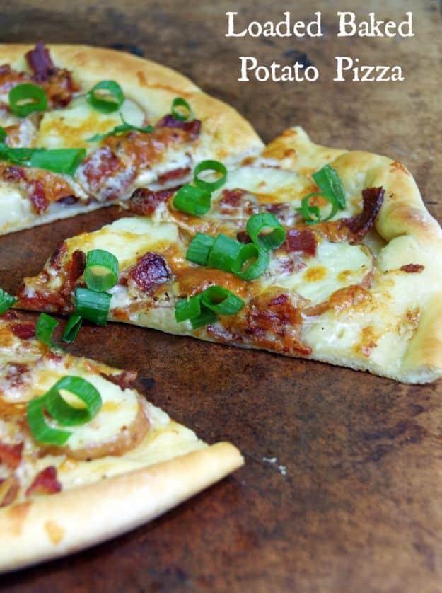 Loaded baked potato pizza slices with bacon, green onion and red onion over white sauce and melted cheese