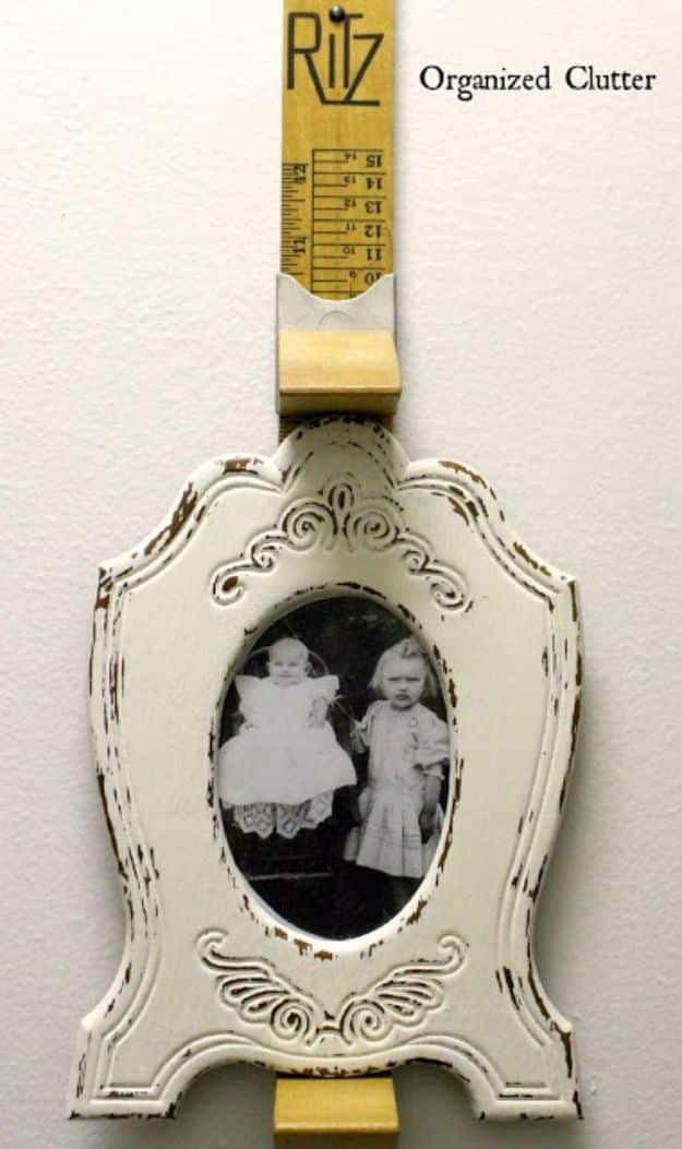 A rusted salvaged metal stand gripping a photo, patina left on the wire, country crafts made from vintage finds