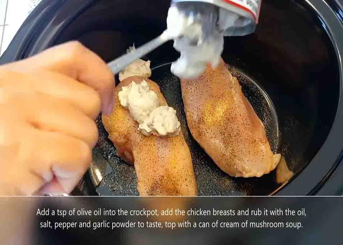 Adding the cream of mushroom over the chicken breasts