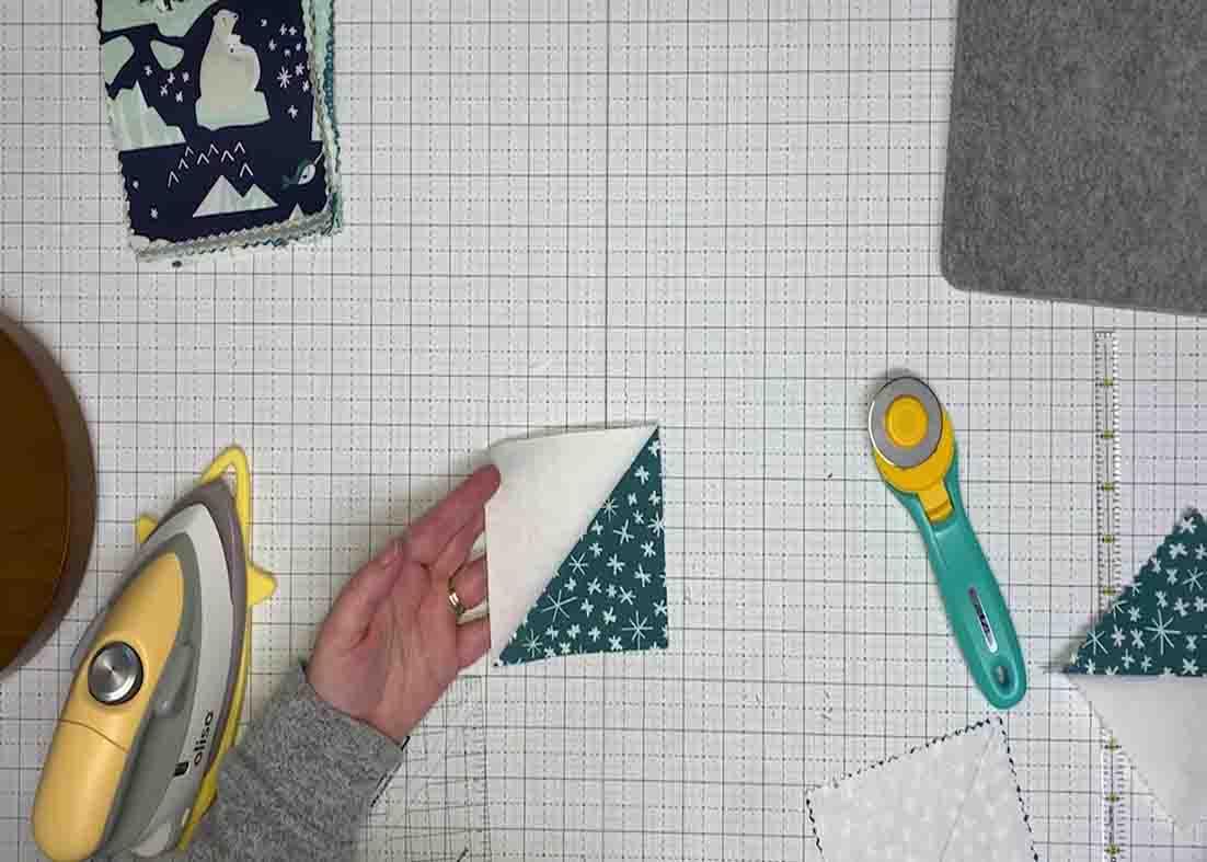 Press down the sewn fabric to open it up