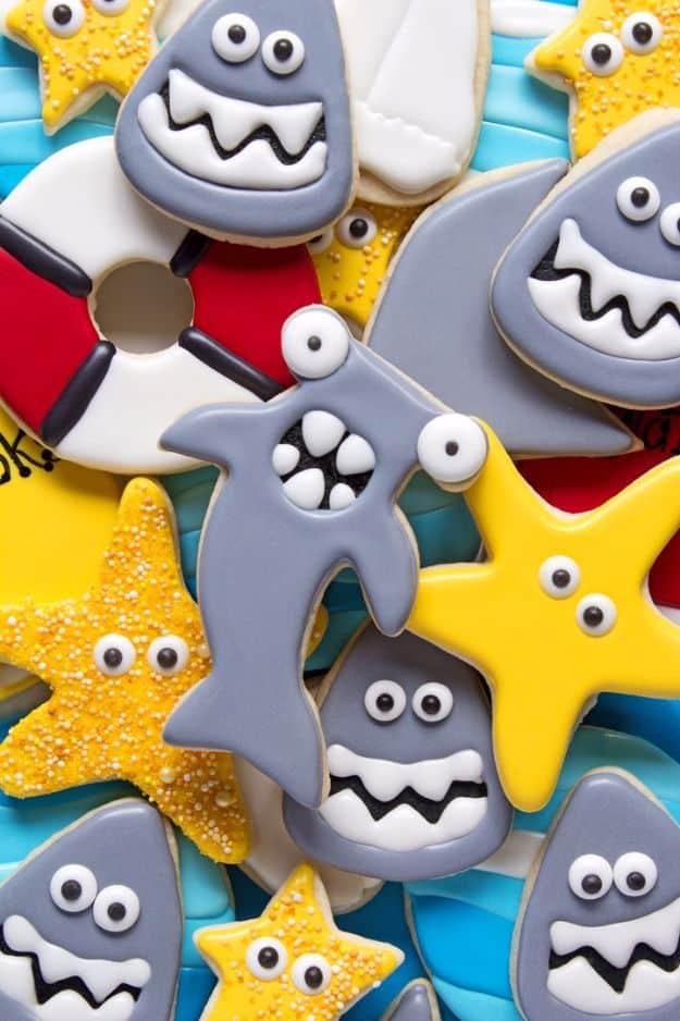 Hammerhead shark cookies decorated in gray royal icing with piped detail on the distinctive wide head