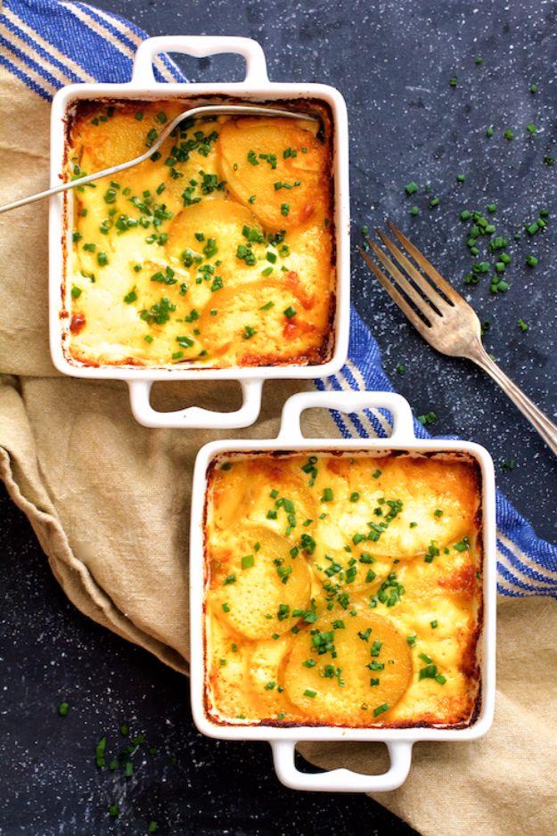 Au gratin potatoes for two baked in individual dishes with sliced potatoes in cream and browned melted cheese