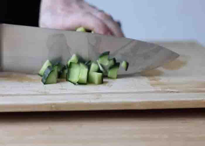 Chopping the cucumber for the chicken orzo recipe