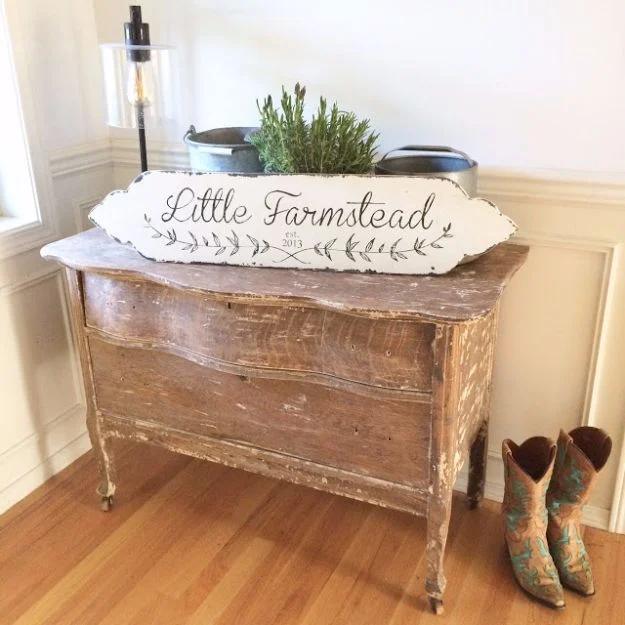 A wide wood sign painted and sanded back to look aged hangs on a wall, its lettering worn at the edges