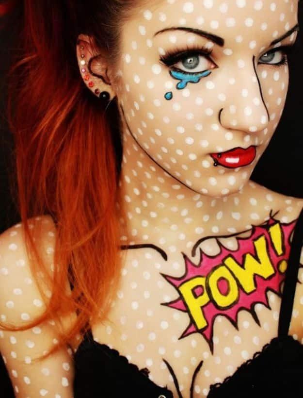Comic book girl Halloween makeup with black halftone dots, glitter tears and a bright yellow POW graphic