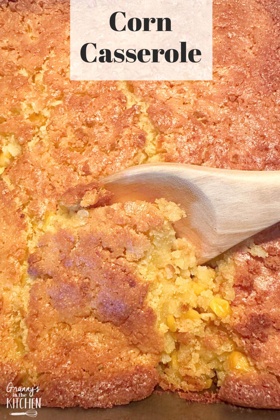 Typeset graphic titled Corn Casserole, a wooden spoon lifting a soft golden scoop from the browned baked casserole