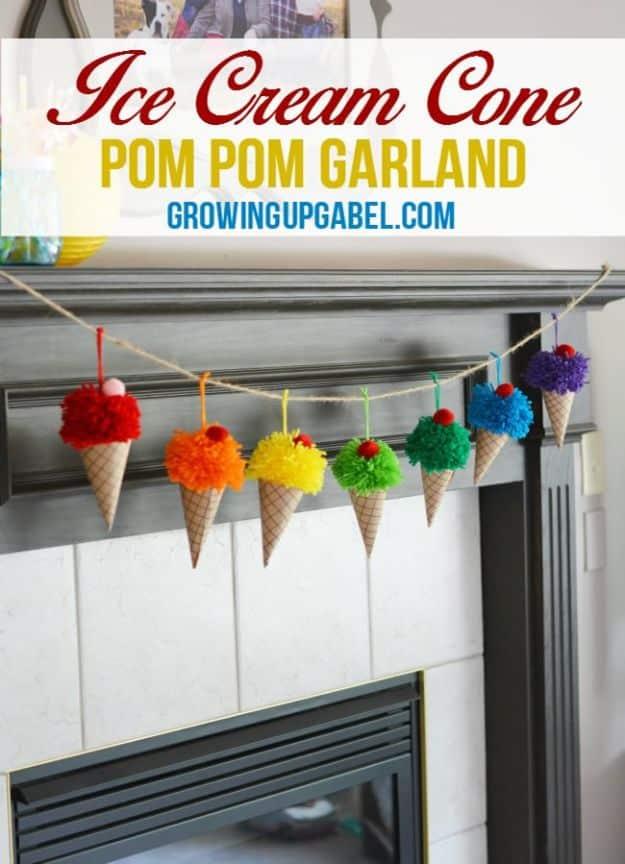 Paper ice cream cone garland with rainbow yarn pom pom scoops and red cherries strung across a white fireplace mantel