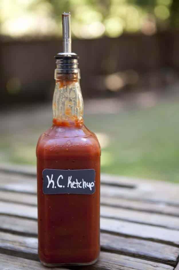Jack Daniels bottles refilled with barbecue sauce and ketchup with pour spouts and chalkboard sticker labels