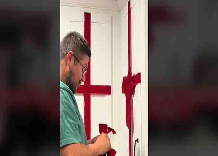 Adding the bows to the ribbon to complete the DIY present cabinets
