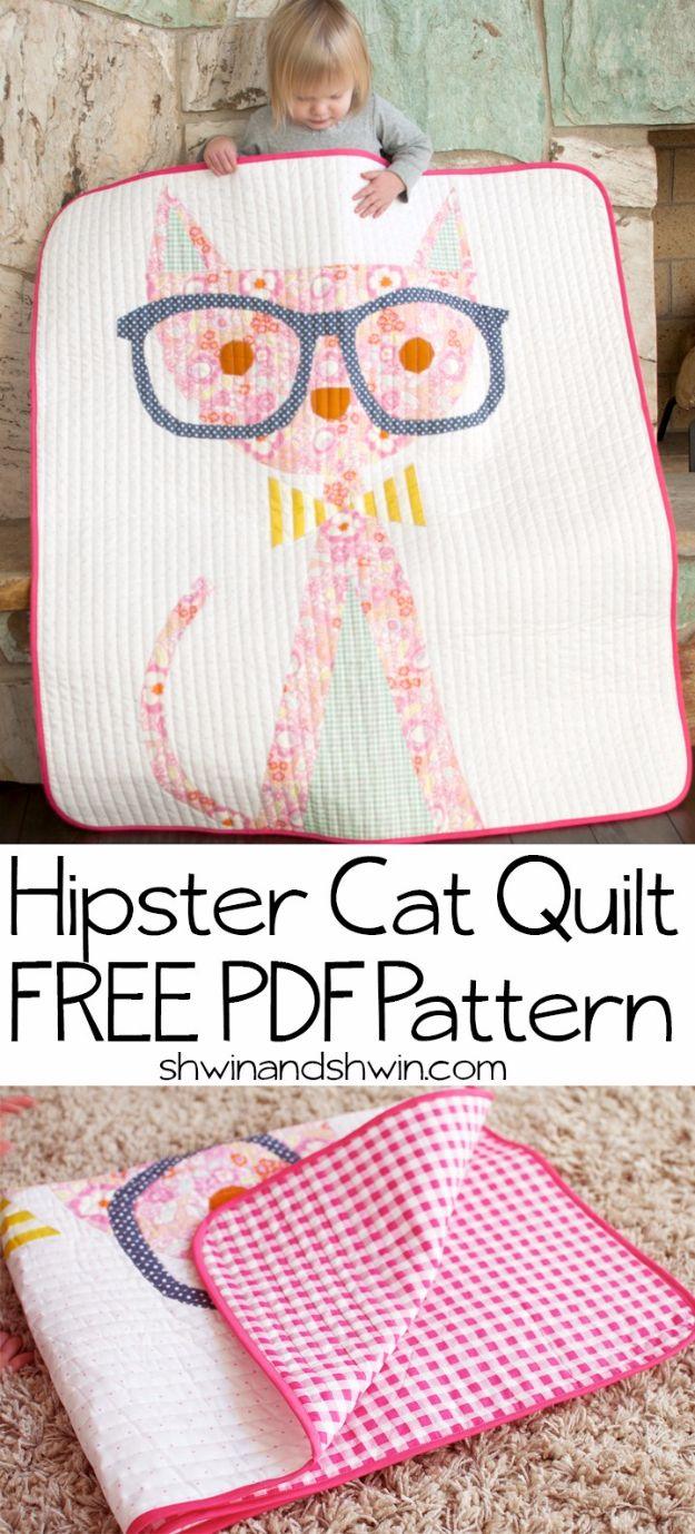 Hipster cat quilt, a large pink and mint cat wearing grey glasses and a striped bow tie on a white quilted ground