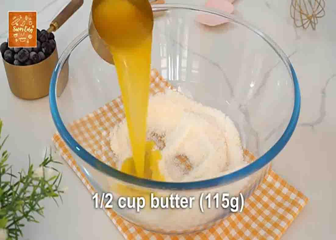 Mixing the ingredients for the blueberry cream cheese muffins