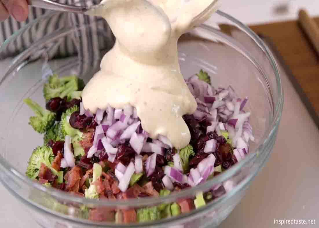 Pouring the dressing to the broccoli salad