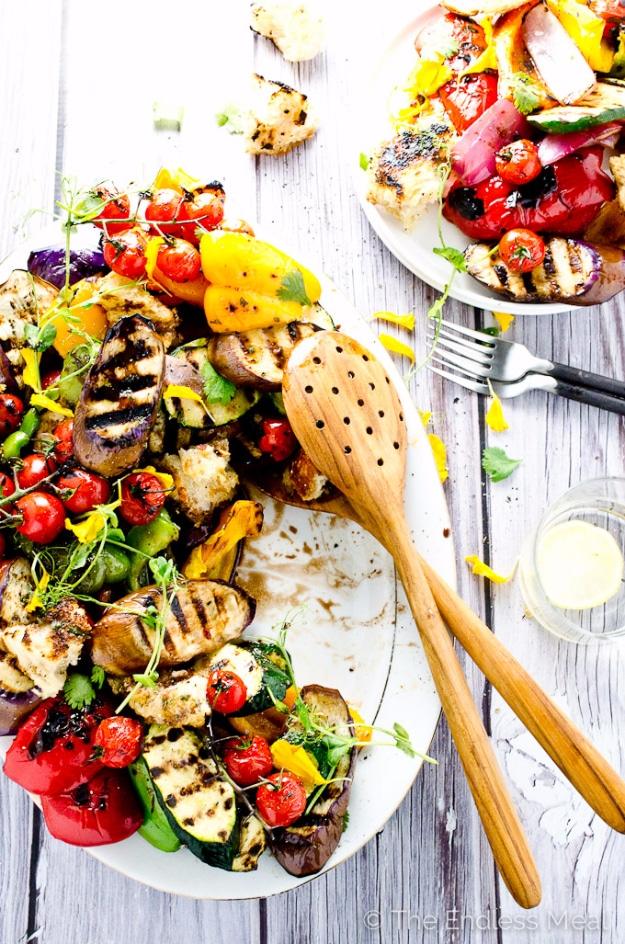 Grilled vegetable salad with charred peppers, eggplant and zucchini under torn giant croutons for a backyard BBQ