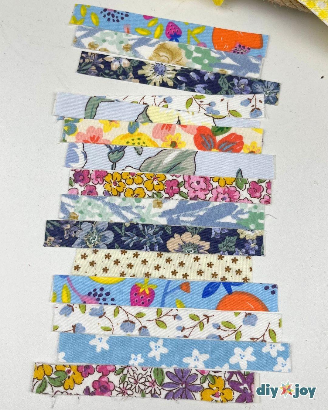 Scrap Fabric Ideas - about twelve strips of floral fabric tape in blue, navy, yellow and cream prints laid flat in rows