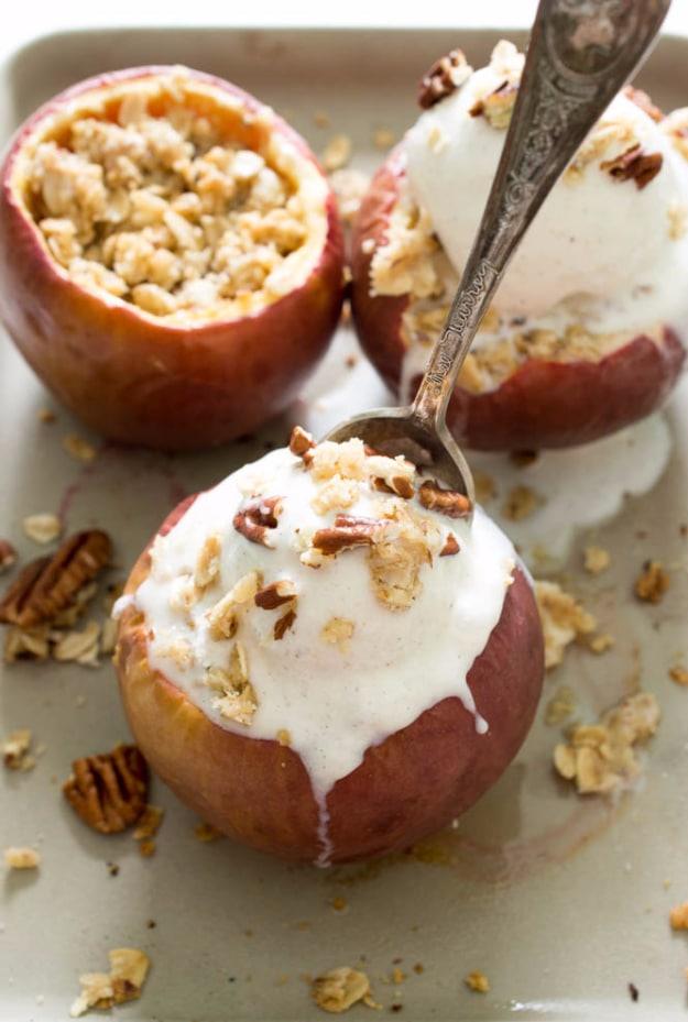 Stuffed baked apple crisp with oat crumble and ice cream, an easy fall dessert idea baked in the apple