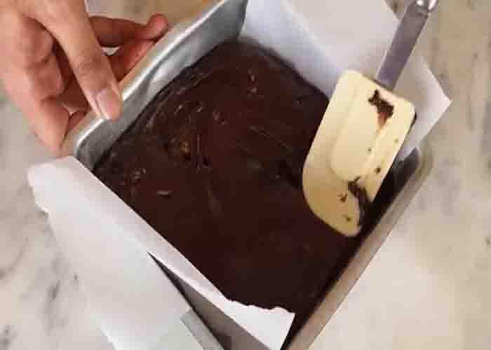 Transferring the chocolate fudge mixture into the pan