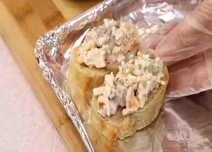 Placing the shrimp and crab toast in the baking tray