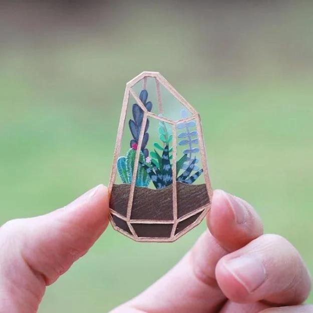 Tiny terrarium layered with moss and stone inside a small glass jar that makes a genuinely thoughtful handmade gift idea