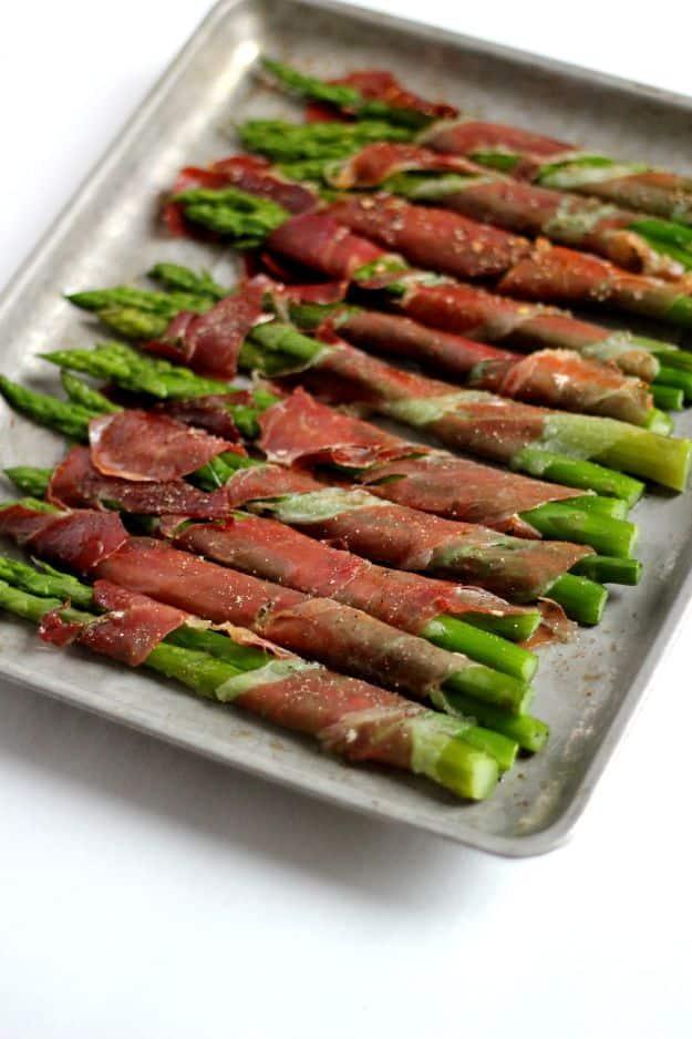 Prosciutto wrapped asparagus spears baked crisp on a sheet pan, a three ingredient gluten free appetizer