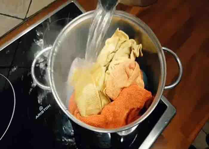 Adding boiling water to the dirty kitchen towels