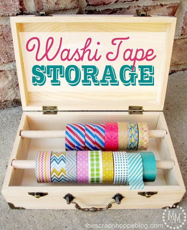 Open wooden box fitted with two dowels holding rolls of washi tape, under a typeset Washi Tape Storage title