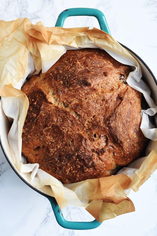 No knead nutty boule baked in a dutch oven, studded with walnuts, pistachios and sunflower seeds too