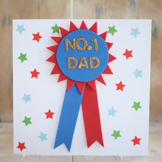 No.1 Dad rosette card, red foam spikes behind a blue circle with gold glitter letters and punched paper stars