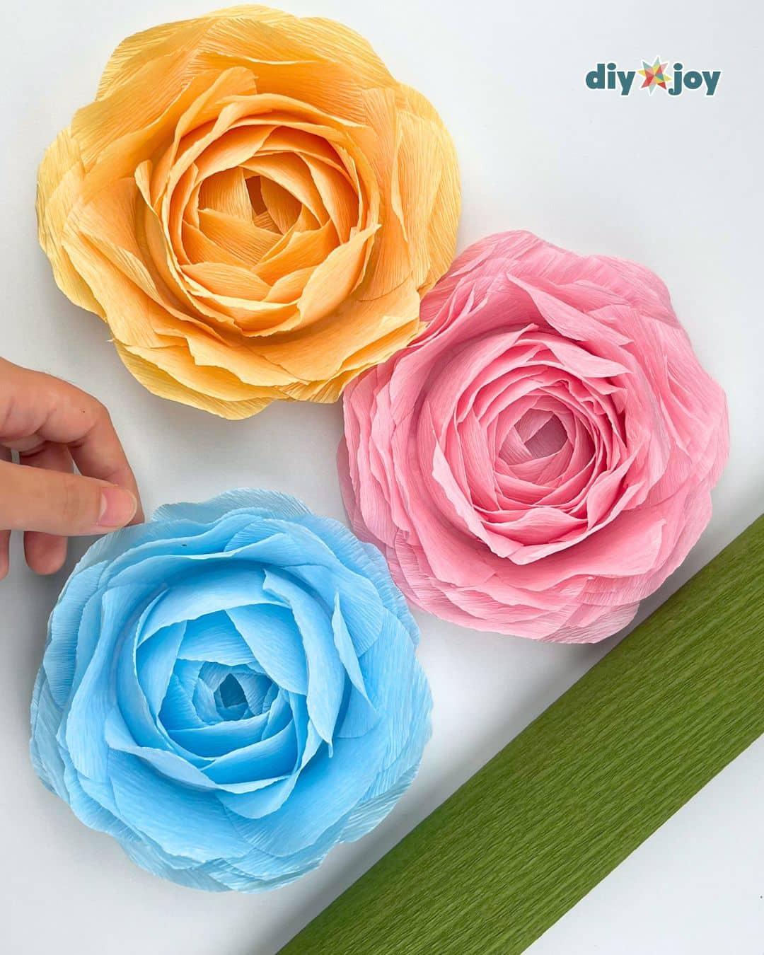 Handmade paper rose flowers shaped using a drinking glass, an inexpensive DIY craft to make and sell or gift